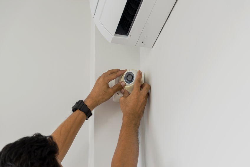 Technicians fixing broken home security system