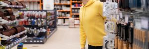 A male shopper looks for an opportunity to steal from a store