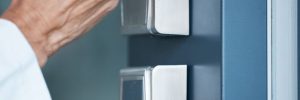Woman using a card at an access control system to get into her office