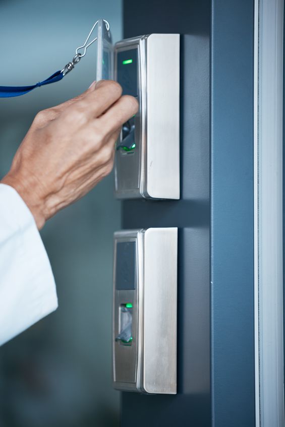 Woman using a card at an access control system to get into her office
